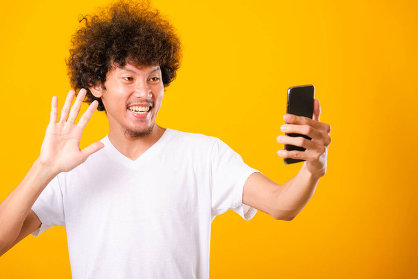 Portrait asian handsome man curly hair taking selfie with mobile - Фото, зображення