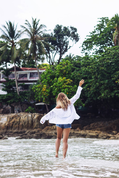 Tanned beautiful caucasian blonde young woman posing on the beach  - Фото, зображення