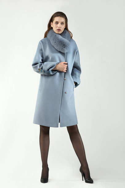 beautiful fashion woman posing in elegant coat at studio - Fotó, kép