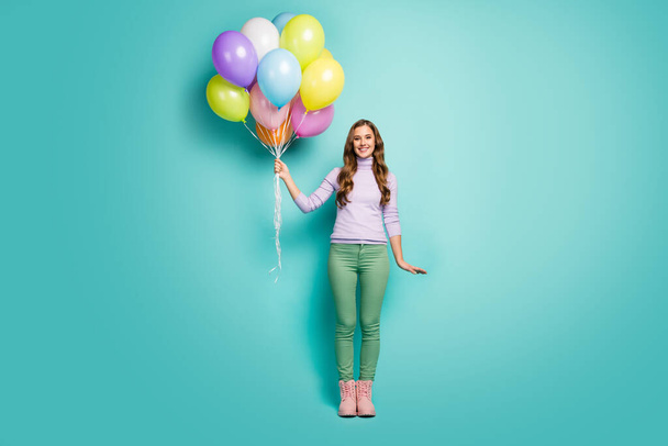 Surprise. Full length photo of pretty funny lady bring many colorful air balloons friends event party wear lilac sweater green pants boots isolated teal pastel color background - Fotoğraf, Görsel