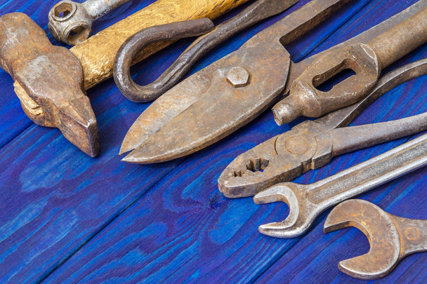 Many vintage craftsman tools stacked after work on blue wooden boards - Zdjęcie, obraz