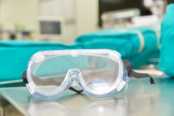 Una gafas protectoras quirúrgicas en la mesa
 - Foto, Imagen