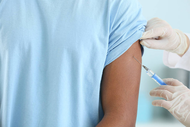 Doctor vaccinating teenage boy in clinic, closeup - Photo, Image