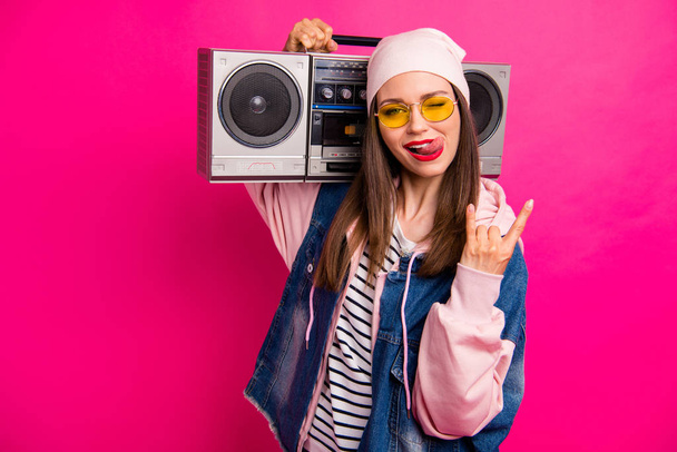 Close-up portrait of her she nice attractive cheerful cheery girl carrying boombox showing horn sign grimacing having fun isolated on bright vivid shine vibrant pink fuchsia color background - Photo, Image