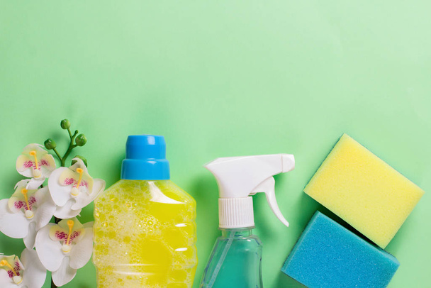 Cleaning set for spring regular clean up on green background. Copy space.  - Фото, изображение