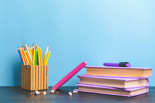 Set of school supplies on table against color background - Foto, afbeelding