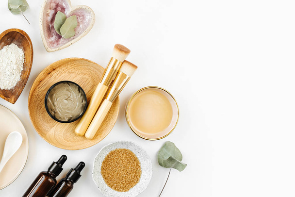 Beauty treatment ingredients for making homemade skin care cosmetic mask. Various bowl with clay, cream, essential oil and natural ingredients  on white table background. Organic spa cosmetic products - Photo, Image