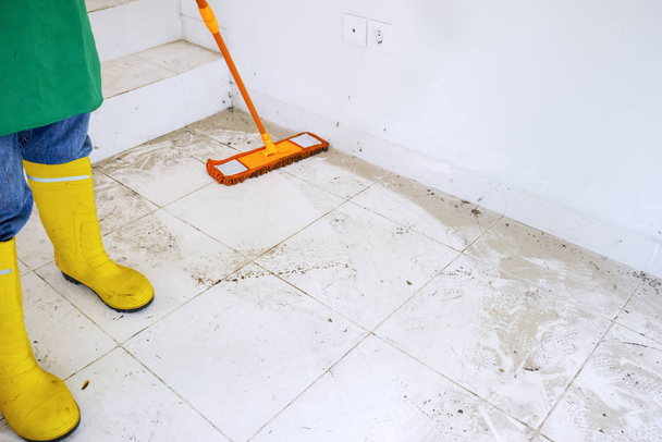 worker mopping dirty floor - Фото, изображение