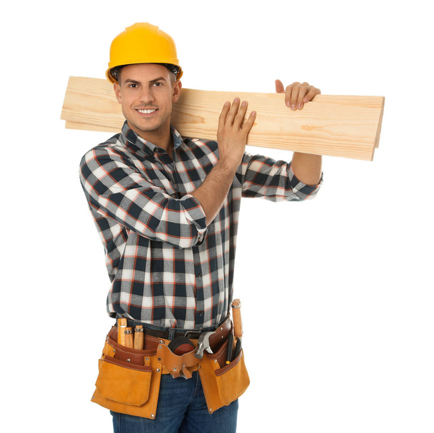 Handsome carpenter with wooden planks isolated on white - Zdjęcie, obraz