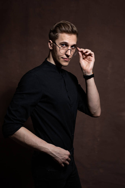 Man in round glasses and a black shirt. - Photo, image