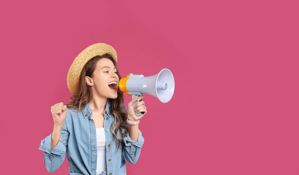Young woman with megaphone on pink background - Foto, Imagen