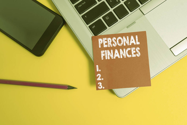 Handwriting text Personal Finances. Conceptual photo the activity of analysing own money and financial decisions Trendy laptop smartphone blank sticky note pencil marker colored background - Photo, Image