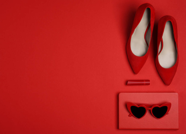 Flat lay composition with stylish women's shoes on red background. Space for text - Фото, изображение