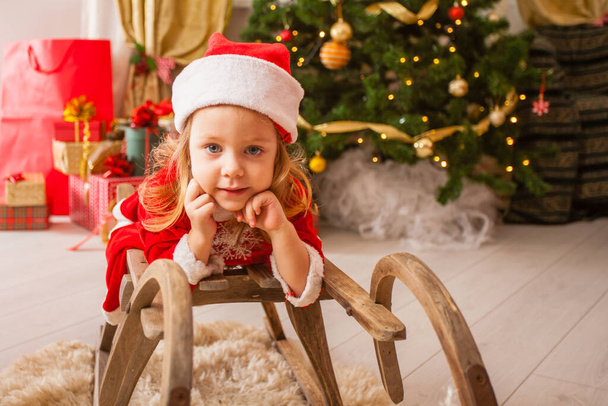 Little child in christmas hat dreaming about christmas miracle. - Photo, image