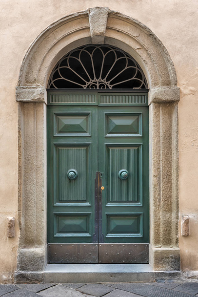 An old decorated vintage door in historical centre of Florence, Italy - Photo, image