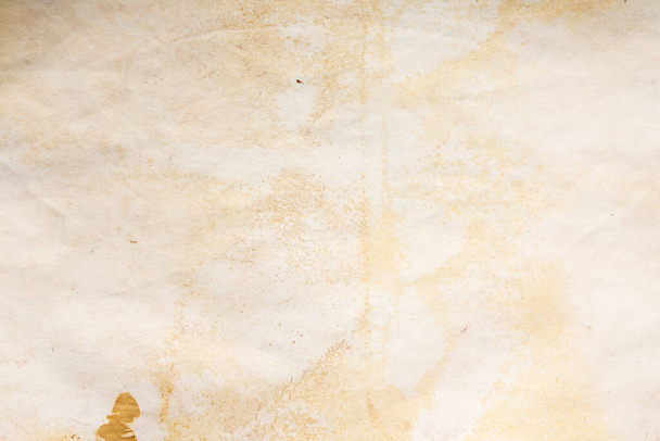 Стареющий лист бумаги. Пустой старый фон с пылью и грязными пятнами. Винтажное и антикварное искусство. Подробная съемка студии крупным планом. Вид спереди. Toned
 - Фото, изображение