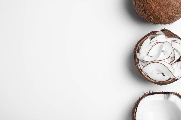 Composition with fresh coconut flakes on white background, top view - Foto, immagini