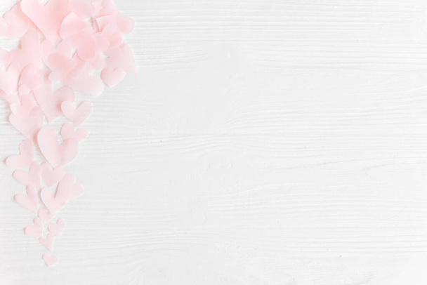 Симпатичные розовые сердечки на белом деревянном фоне с пространством.
 - Фото, изображение