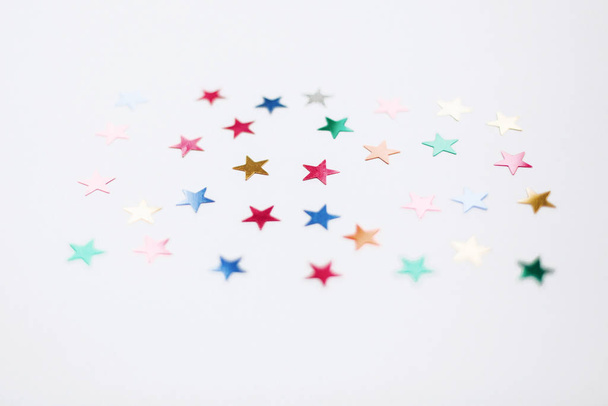 Colorful stars confetti or glitter on white background. Party ba - Photo, image