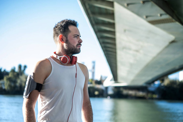 man playing sports and listening to music with headphones - 写真・画像