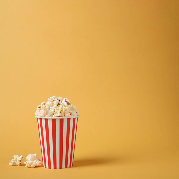 Delicious popcorn on yellow background. Space for text - Foto, afbeelding