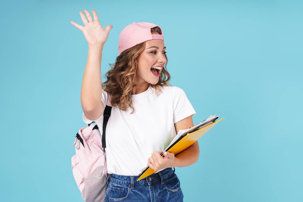 Cheerful cute girl student carrying backpack - Foto, imagen