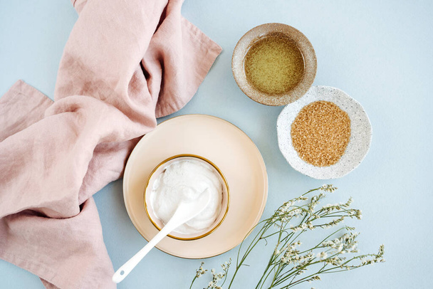 Beauty treatment ingredients for making homemade skin care cosmetic mask. Various bowl with clay, cream, essential oil and natural ingredients  on white table background. Organic spa cosmetic products - Φωτογραφία, εικόνα
