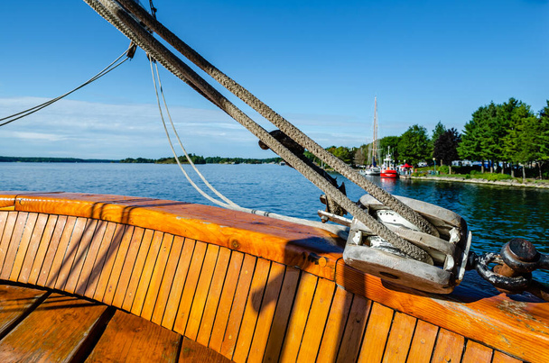 Close-up of stern sail rope pulley and the St. Lawrence River fr - Photo, Image