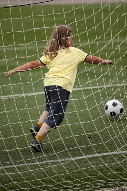 child run soccer (football) player. Boy with ball on green grass - Zdjęcie, obraz