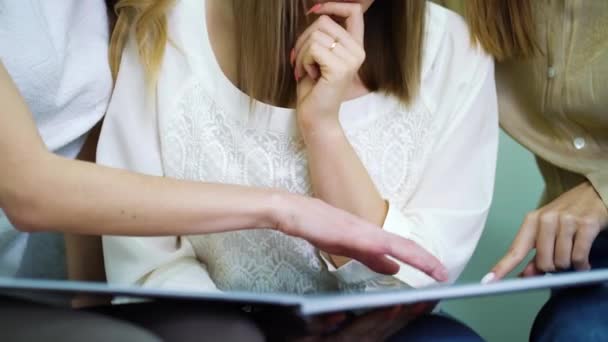 Hands of happy bride and bridesmaids watching catalog of wedding dresses - Filmmaterial, Video