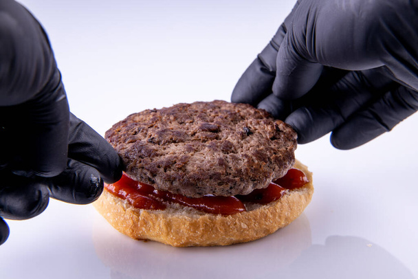 phased assembly of a hamburger on a light background16 - Photo, Image