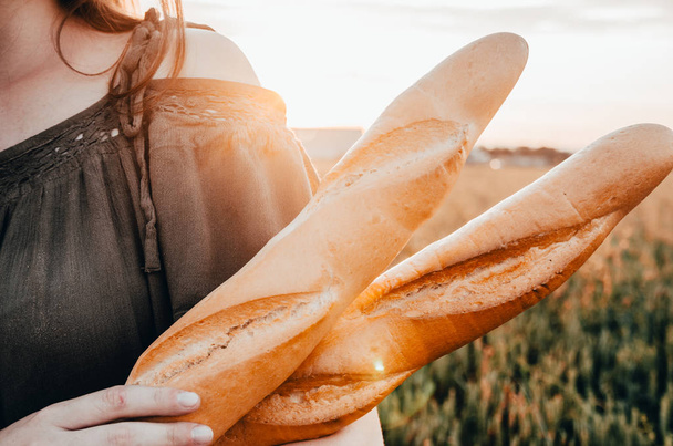 french baguette in wheat field - Φωτογραφία, εικόνα