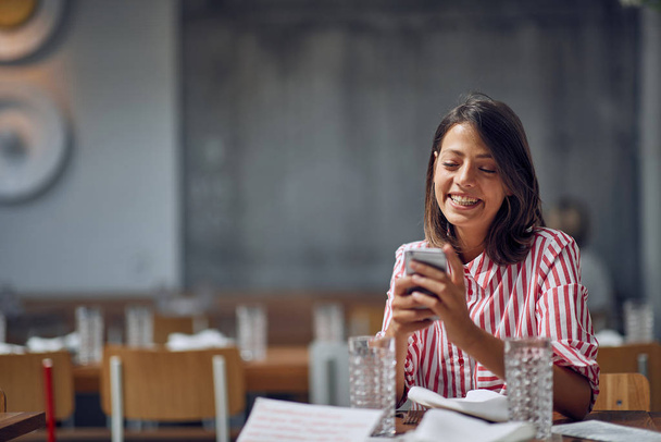Smiling girl in  caffe use smartphone in cafe.People Meeting Friendship Coffee Shop Concept - 写真・画像