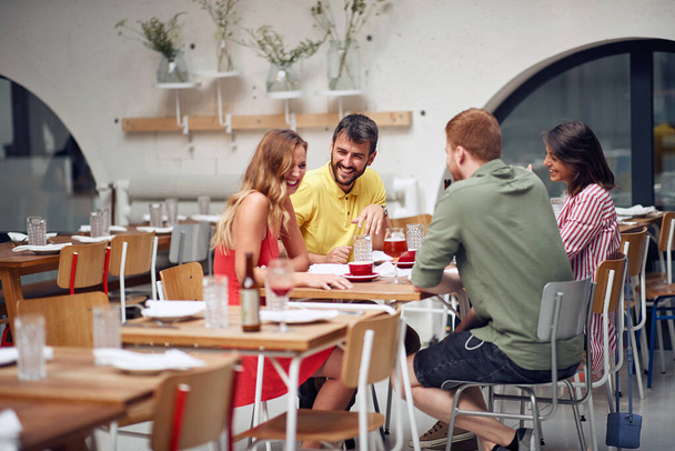 friends laughing and enjoying at coffee together - Photo, Image