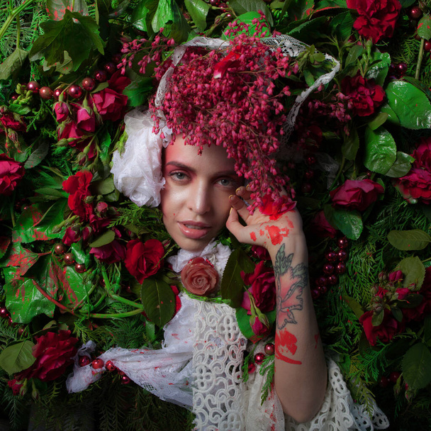 Female portrait in fairy tale stylization surrounded with natural flowers. - Fotografie, Obrázek