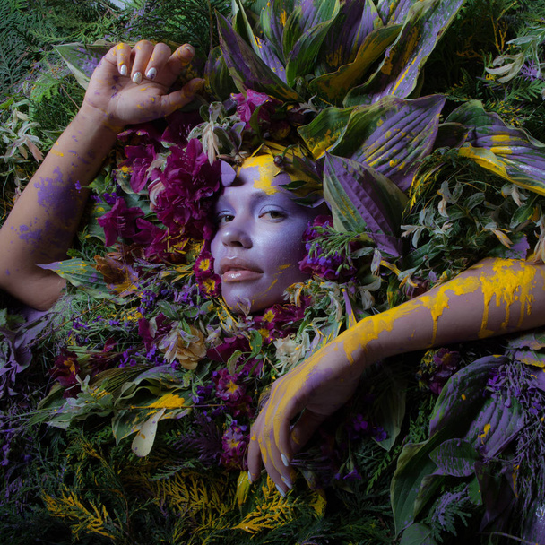 Female portrait in fairy tale stylisation surrounded with natural plants and flowers. - Fotó, kép