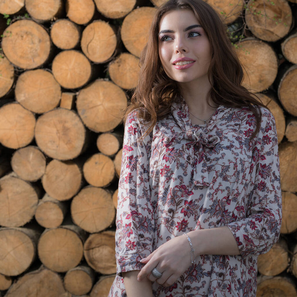 Portrait of beautiful young girl on wooden background. - Фото, зображення