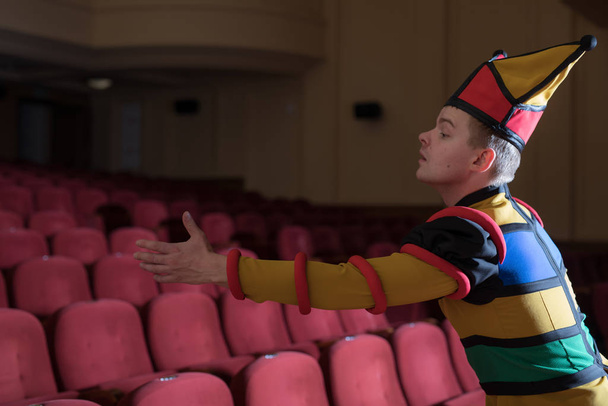 Actor dressed jesters costume in interior of old theater.  - Фото, зображення