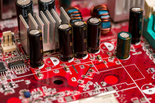 Red printed computer motherboard - Foto, afbeelding