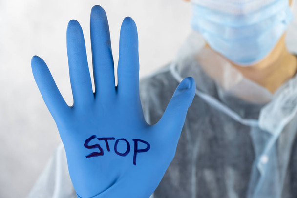 stop the coronavirus, China virus. on the medical glove the inscription stop. Concept of coronavirus quarantine.  - Photo, Image