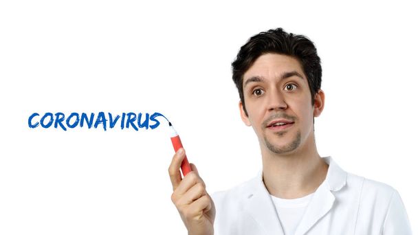 Text " coronavirus" on white background. Young male european scientist, tech, doctor or medical specialist explains about virus infections and epidemics. - 写真・画像