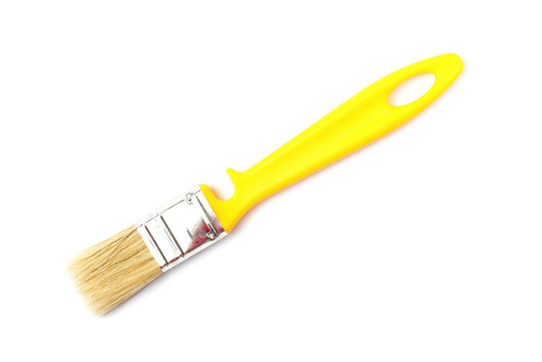 Paint brush with a yellow handle close-up on a white background. - Φωτογραφία, εικόνα