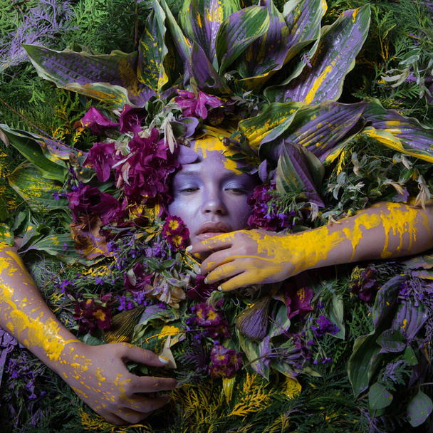 Female portrait in fairy tale stylisation surrounded with natural plants and flowers. - Fotoğraf, Görsel