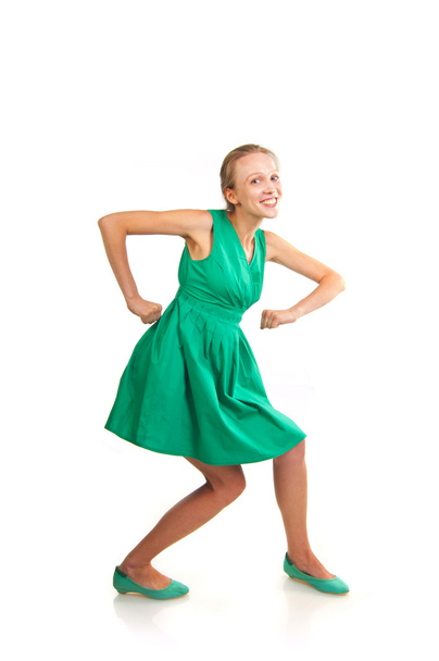 Woman in green dress making funny moves - Photo, image