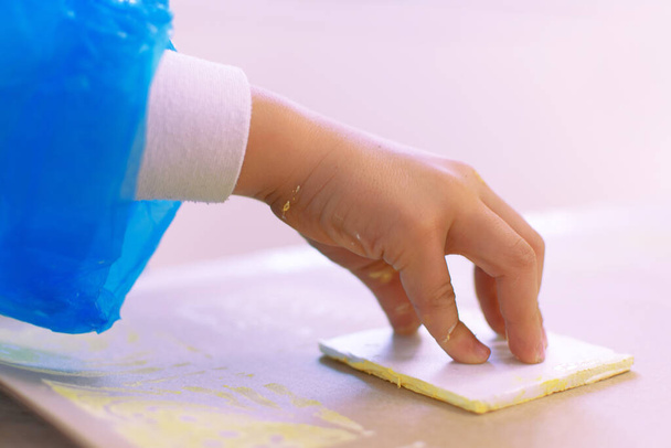 Close-up of a children in art therapy class drawing, painting and practicing engraving art. Child education in primary school at art class in Spain - Fotoğraf, Görsel