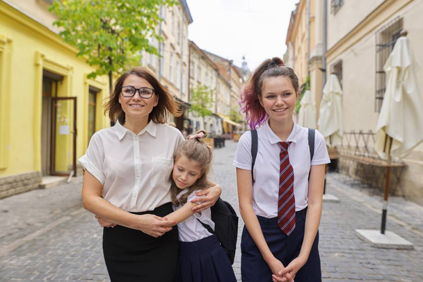 Happy mother and daughters going to school - Valokuva, kuva