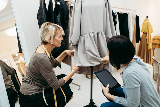 Two professional designers working in fashion studio. Creative people concept. - Foto, imagen