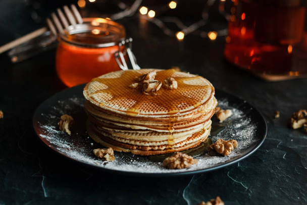 Dutch waffles with honey and nuts. Romantic composition with candles and other elements - Фото, зображення