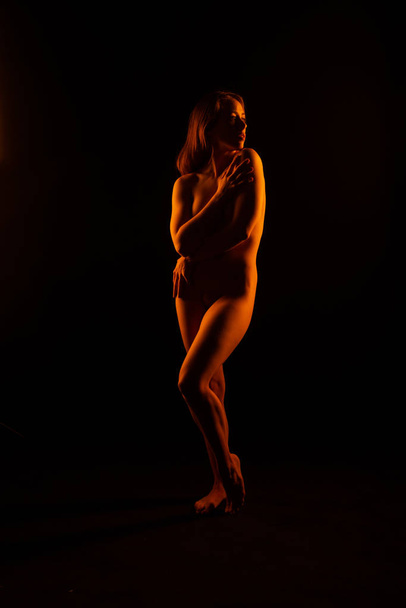 Brunette nude in orange - Zdjęcie, obraz
