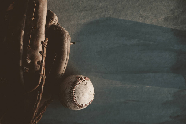 Old used baseball with glove on dark background, copy space for sports concept. - Fotografie, Obrázek